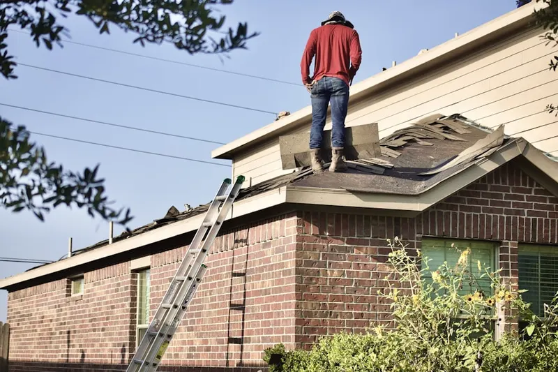 Professional roofer working on a residential roof in Orwell
